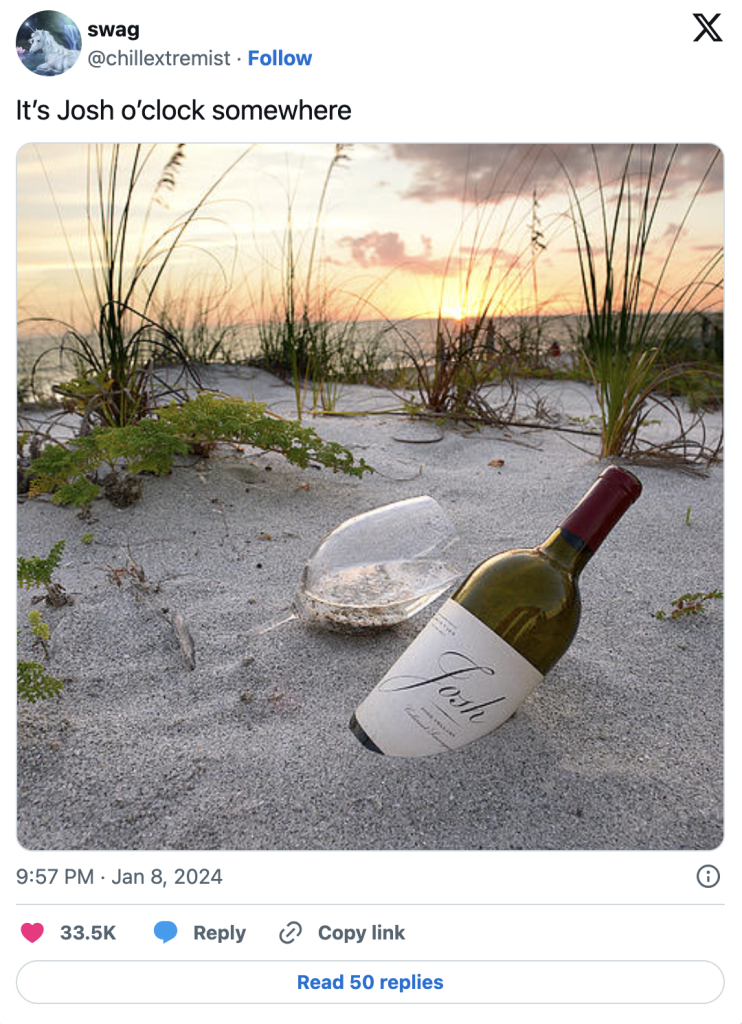 wine bottle and glass in sand