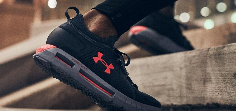 up close images of a black running shoe  with Under Armour logo on the side